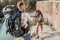 Curly dark-haired woman with heavy backpack feeling tired hiking with her man