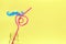 Curly drinking straws in a bottle on yellow background. Drinking straw day concept