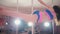 Curly girl dancing on the pole in the studio