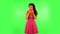 Curly girl inflates a bright red ball then rejoicing. Green screen