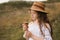 Curly girl in a straw hat eats ice cream in the village in the summer..Retro vintage, happy childhood concept