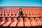 Curly girl in a surgical mask sitting in an empty stadium during epidemic disease Covid-19