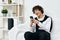 curly guy sitting on a white sofa smartphone Lifestyle technology