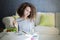 Curly hair teen girl reading book and eating salad