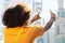 Curly-haired woman taking photos with transparent device