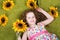 Curly little girl with sunflower