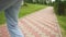 Curly schoolgirl in a mask and with a backpack rides on a skateboard after school. Back to school after quarantine. Post