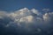 Curly thick clouds and clouds in the blue sky in the evening in late spring.