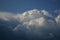 Curly thick clouds and clouds in the blue sky in the evening in late spring.