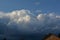 Curly thick clouds and clouds in the blue sky in the evening in late spring.