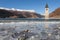 The Curon Bell tower appearing from frozen waves of lake, Resia, South Tyrol, Italy