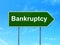 Currency concept: Bankruptcy on road sign background