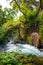 Current of the river and a tree in the moss. Upper Duden Waterfalls, Turkey, Antalia. Travel photography.