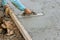 Currently, a worker is holding a steel trowel and smoothing plaster on freshly poured concrete sidewalk