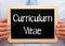 Curriculum Vitae - Manager holding chalkboard with text