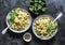 Curried creamy salmon with pasta on a dark background, top view