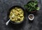 Curried creamy salmon with sauce on a dark background, top view