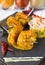 Curried King Prawns on metal skewers, served on a slate plate, with dry chilli and yoghurt.