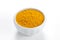 Curry ground in a white bowl on white background.
