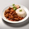 curry with rice on a white plate on a gray background.