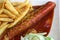 Currywurst curry sausage with french fries and cucumber salad and tomato ketchup