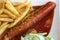 Currywurst curry sausage with french fries and cucumber salad and tomato ketchup