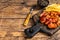 Currywurst Sausages street food served French fries on a wooden board. wooden background. Top view. Copy space