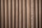 Curtain of brown color hanging and forming drapery
