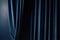 curtain setting, with dark blue backdrop and drapes, against window view