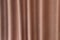 Curtain wave with a pattern background, macro texture of brown striped fabric