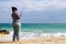 Curvaceous woman taking a selfie by the sea