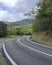 Curve asphalt road in tropical island. Bend street up to the mountain. Serpentine road in forest