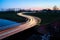 Curve light trails on country road in the landscape of the province of Groningen, The Netherlands