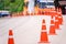 Curve line of orange traffic cone on the road at the Pa Hin Ngam National Parkthe big green field of Siam Tulip at Chaiyaphum, Th