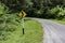 Curve warning sign along small road