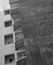 Curved balconies and square windows in an old stained concrete apartment building