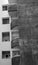 Curved balconies and square windows in an old stained concrete apartment building