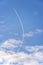 Curved contrail. Jet airliner plane flying at altitude leaving curving contrails
