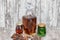 A curved crystal decanter with homemade moonshine stands on a wooden stand