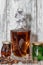 A curved crystal decanter with homemade moonshine stands on a wooden stand