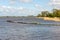 Curved dam of basalt boulders in the water of a river