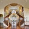 The curved dual grand staircase in an upscale home.