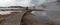 Curved Elevated wooden boardwalk going past Black Warrior Hot Springs and Tangled Creek into Hot Lake in Yellowstone National Park