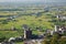 A curved highway through the green rice fields with houses scattered throughout the plain in Yilan, Taiwan