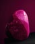 A curved magenta stone worn to a smooth finish by years of exposure. Trendy color of 2023 Viva Magenta.. AI generation