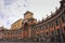 Curved orange building of Convitto Nazionale with clock tower at Piazza Dante Square Napoli, Naples, Italy