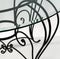 Curved ornaments of wrought iron. Detail of table