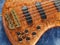 Curved patterned wood bass guitar closeup