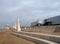 The curved promenade along the seafront at cleveleys in blackpool with steps leading to the beach with town buildings behind the