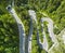 Curved road with cars and beautiful forest landscape.